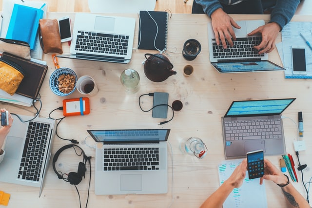 an office desk with laptops