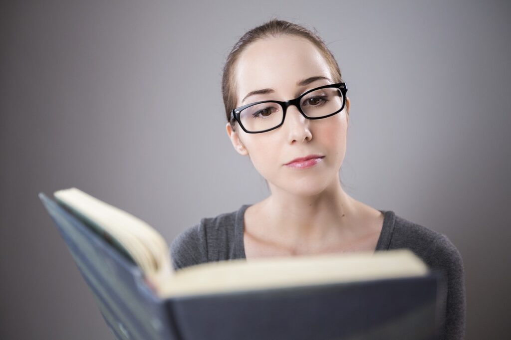 A young businesswoman learning a new business strategy from a book